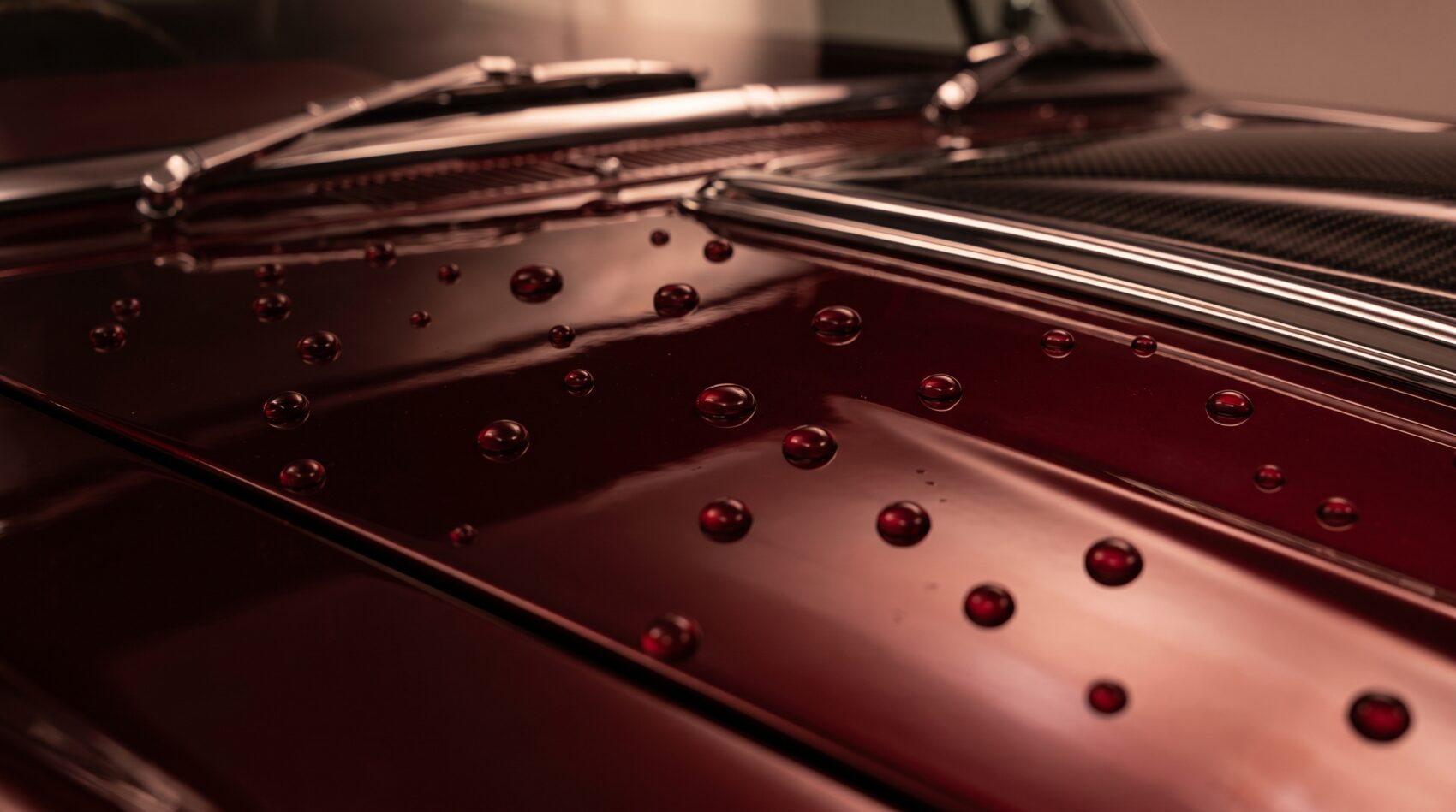 Water beading on a ceramic-coated deep-red hood